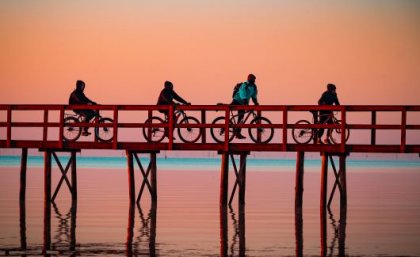 Staying active throughout adulthood - even with simple activities like a sunrise bike ride at the Trapiche in Pelotas, Brazil - is beneficial and can have lasting effects. Image: Dr Gregore Iven Mielke Four cyclists getting outside for sunrise at the Trapiche in Pelotas, Brazil